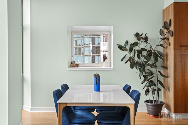 dining room with baseboards and wood finished floors