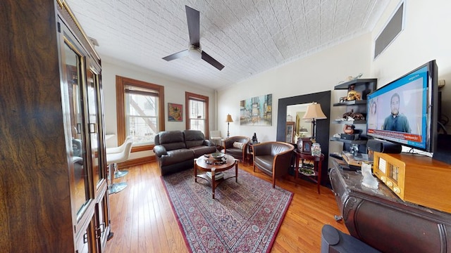 living room featuring wood-type flooring and ceiling fan