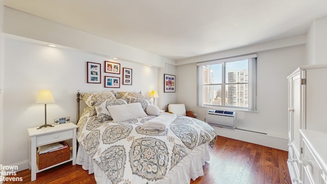 bedroom featuring dark wood-style floors and a wall mounted AC