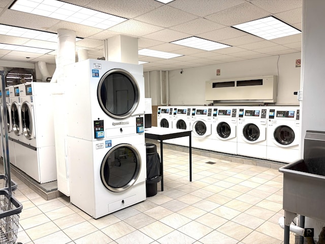 common laundry area with washer and clothes dryer, light tile patterned floors, and stacked washer and clothes dryer