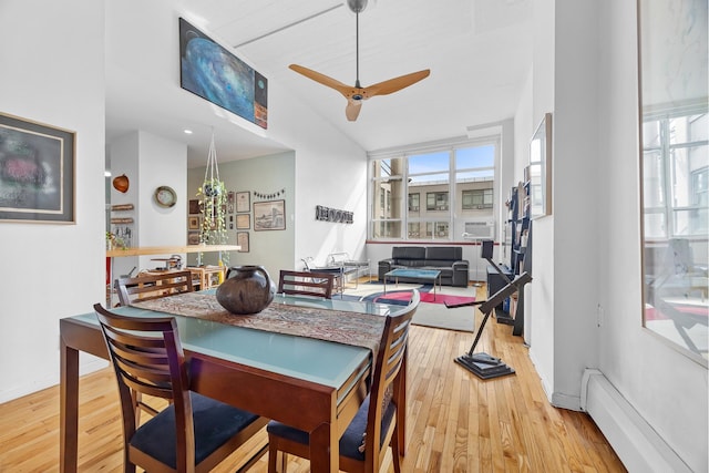 dining room featuring a ceiling fan, wood finished floors, and a baseboard radiator