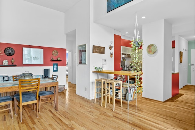 dining room with recessed lighting, baseboards, and wood finished floors