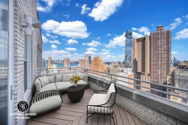 wooden terrace with a view of city and outdoor lounge area