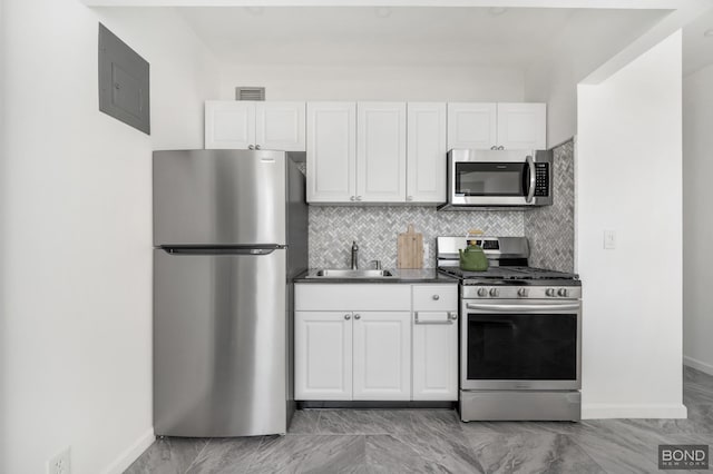 kitchen with white cabinets, visible vents, appliances with stainless steel finishes, and a sink