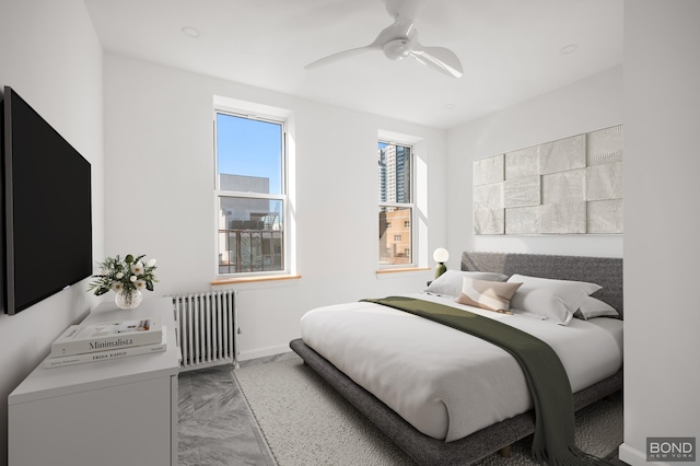 bedroom with radiator, baseboards, and ceiling fan