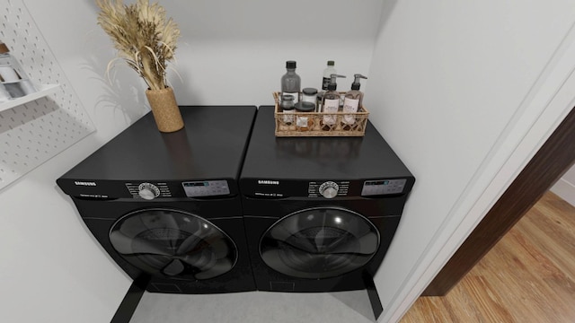 27-28 Thomson Ave Unit S415, New York City, NY 11101 - laundry area featuring washing machine and dryer and wood finished floors