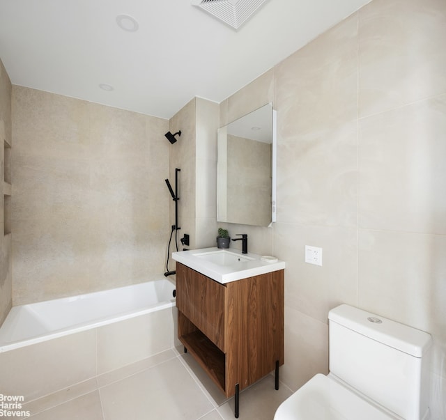 full bathroom featuring visible vents, washtub / shower combination, toilet, tile patterned floors, and tile walls