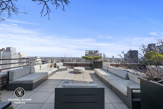 view of patio featuring an outdoor living space and a city view