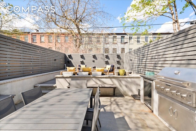 view of patio / terrace with outdoor dining space, exterior kitchen, outdoor lounge area, and a grill