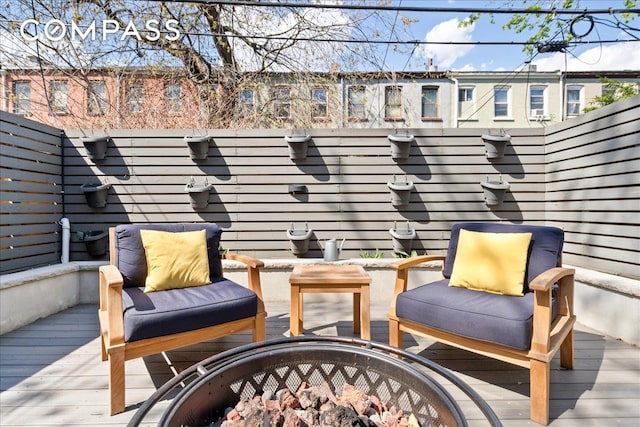 wooden terrace featuring outdoor lounge area and fence