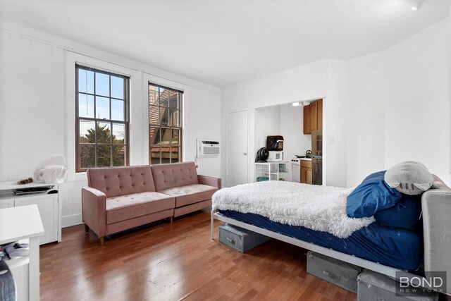 1 Station Sq Unit 311, New York City, NY 11375 - bedroom with wood finished floors and a wall unit AC