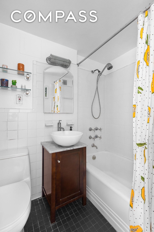 bathroom featuring tile patterned flooring, shower / tub combo with curtain, tile walls, and vanity