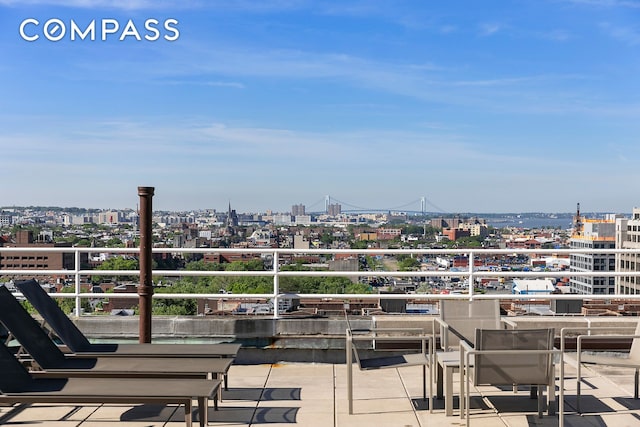 view of patio / terrace with a view of city and a balcony