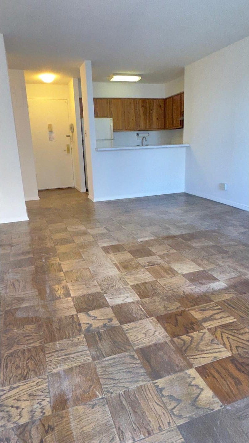 interior space featuring brown cabinets and freestanding refrigerator