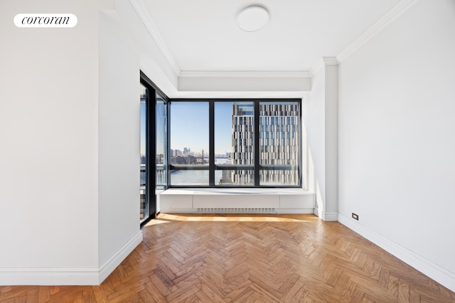 unfurnished room featuring visible vents, baseboards, ornamental molding, and a view of city