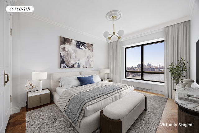 bedroom with crown molding, a view of city, and an inviting chandelier