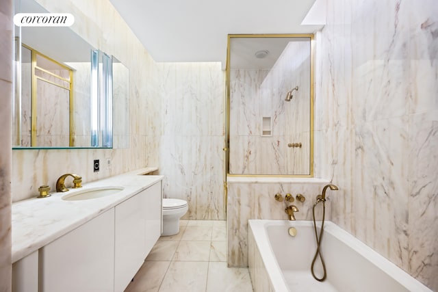 full bath with vanity, a tub, tile walls, toilet, and marble finish floor