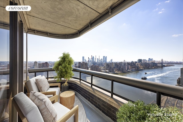 balcony with a water view and a city view