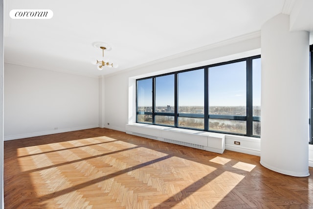 530 E 76th St Unit 23H, New York City, NY 10021 - empty room with plenty of natural light, crown molding, baseboards, and a chandelier