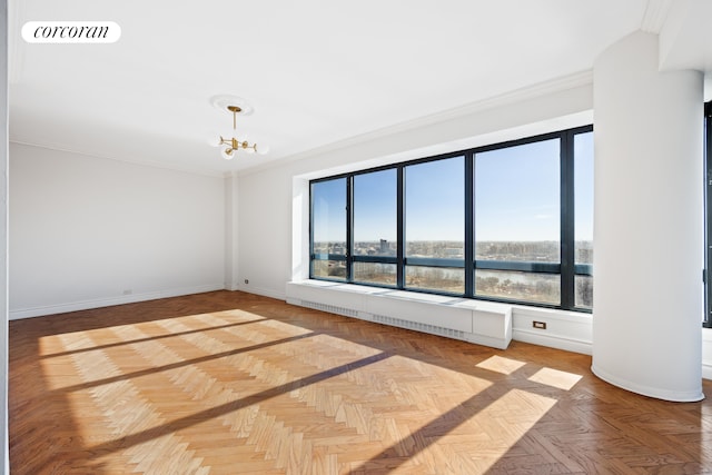 unfurnished room featuring a notable chandelier, visible vents, baseboards, and ornamental molding