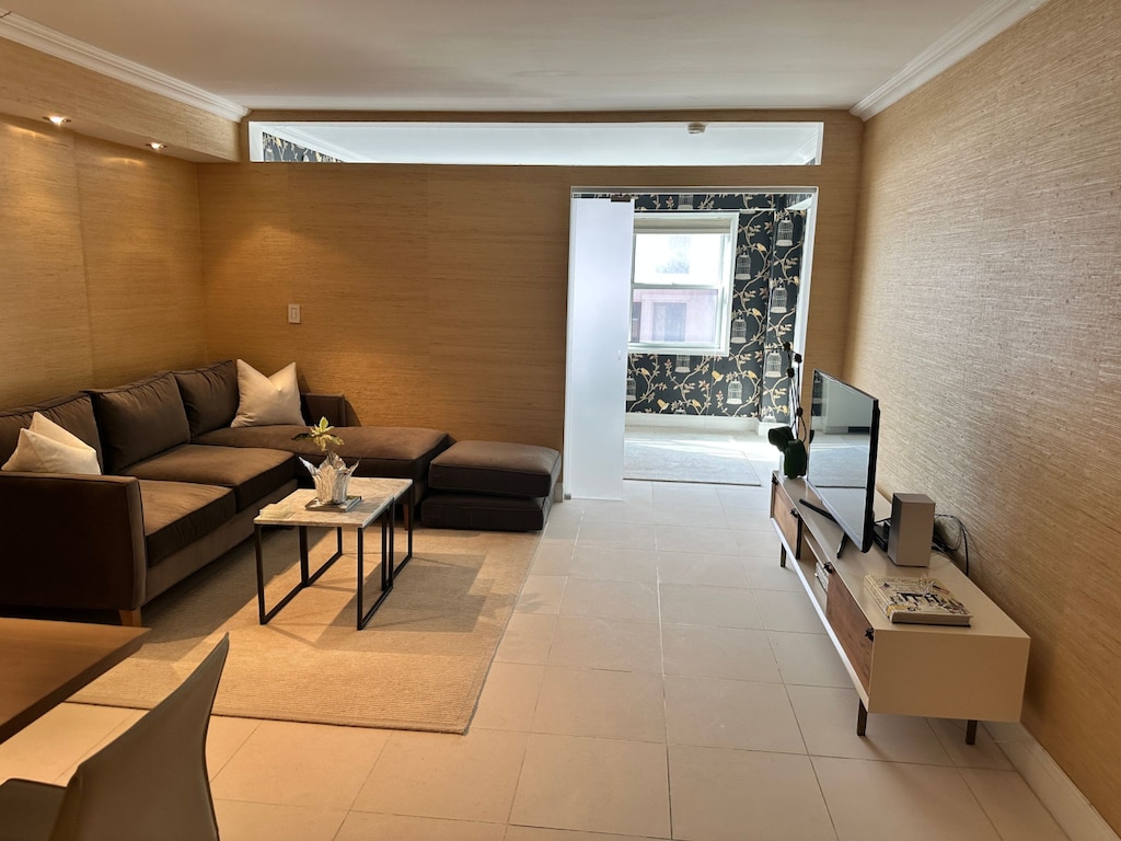 27 E 65th St Unit 7C, New York City, NY 10065 - living room with wallpapered walls, crown molding, and light tile patterned floors