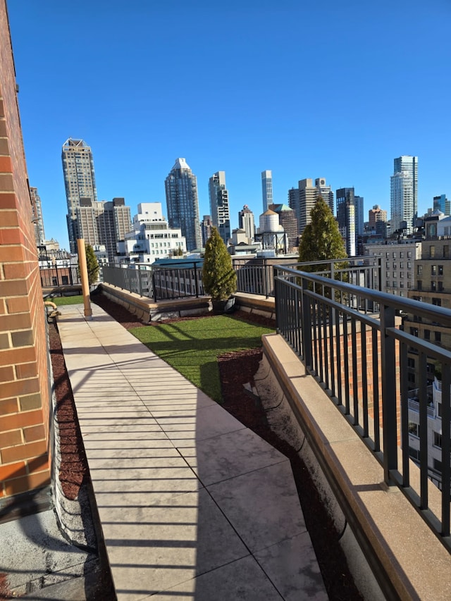 view of patio / terrace with a balcony and a city view