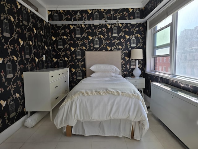 bedroom featuring light tile patterned floors, wallpapered walls, and ornamental molding