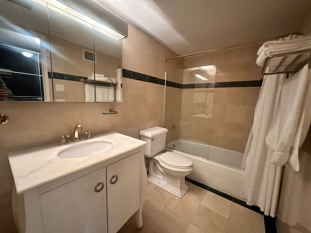 full bath featuring vanity, bathtub / shower combination, decorative backsplash, tile walls, and toilet