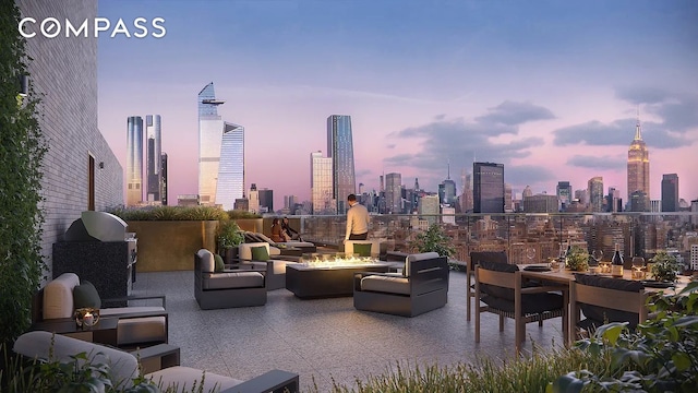515 W 18th St Unit 403, New York City, NY 10011 - patio terrace at dusk featuring a view of skyline and an outdoor living space with a fire pit