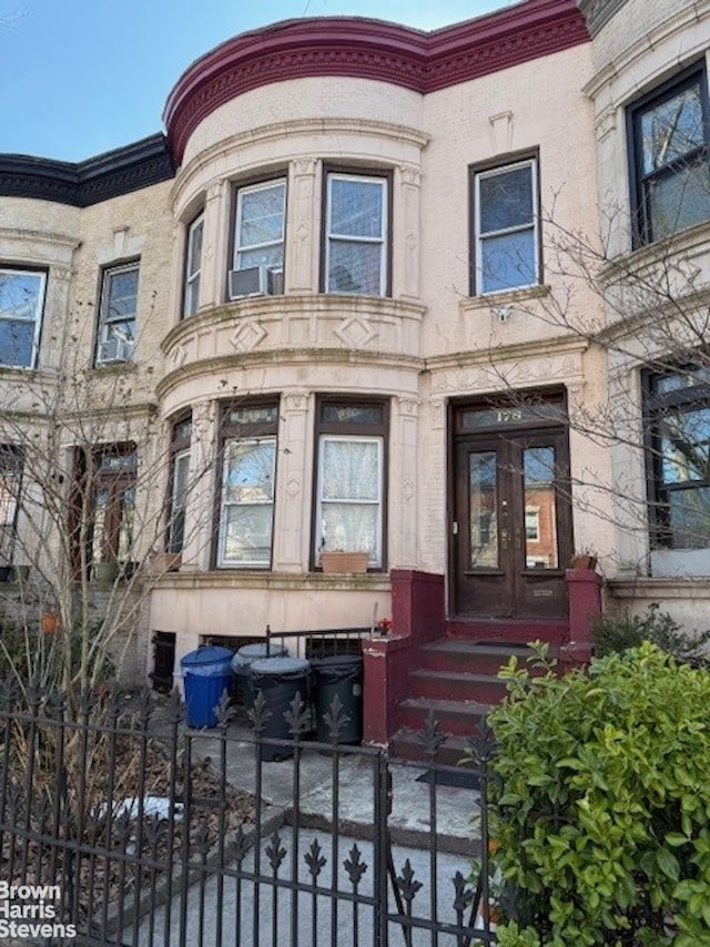 view of exterior entry featuring a gate and fence