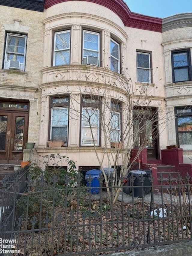 exterior space featuring french doors and a fenced front yard