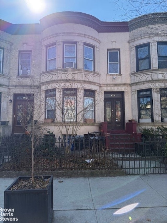 view of front of house with french doors and a fenced front yard