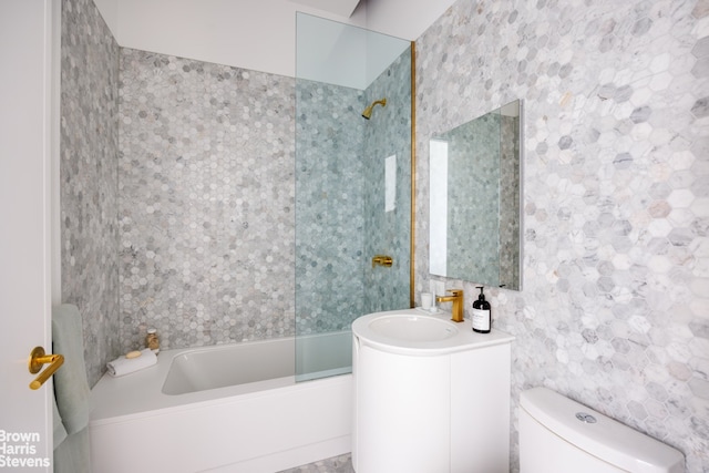 bathroom with vanity, toilet, and  shower combination