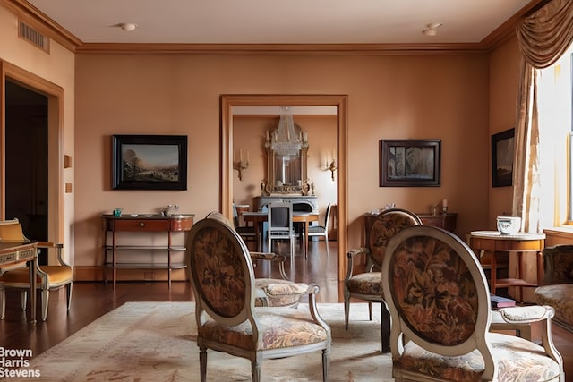 interior space featuring visible vents, crown molding, baseboards, and wood finished floors