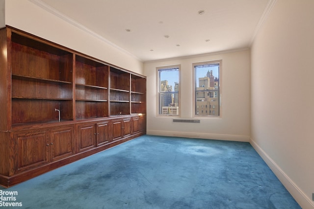 empty room featuring crown molding, carpet flooring, and baseboards