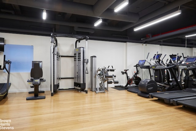 workout area with wood finished floors