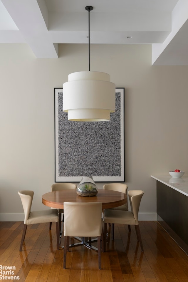 dining area featuring hardwood / wood-style floors and baseboards