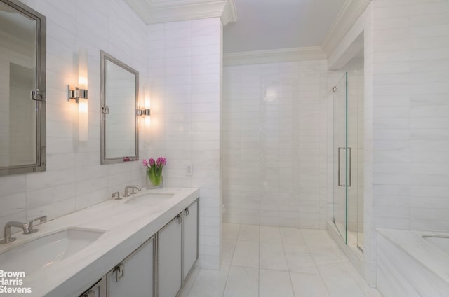 bathroom with a sink, a stall shower, tile walls, and ornamental molding