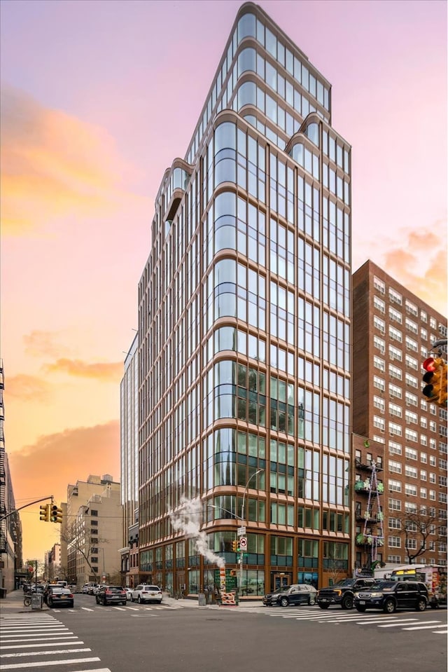 property at dusk featuring a view of city