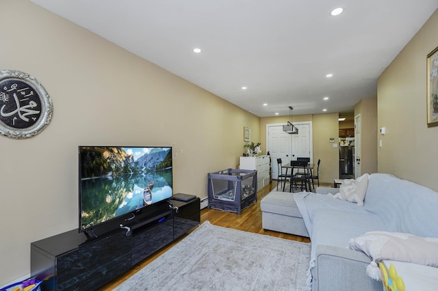 9729 4th Ave Unit 3-C, New York City, NY 11209 - living room featuring wood finished floors, recessed lighting, and a baseboard radiator