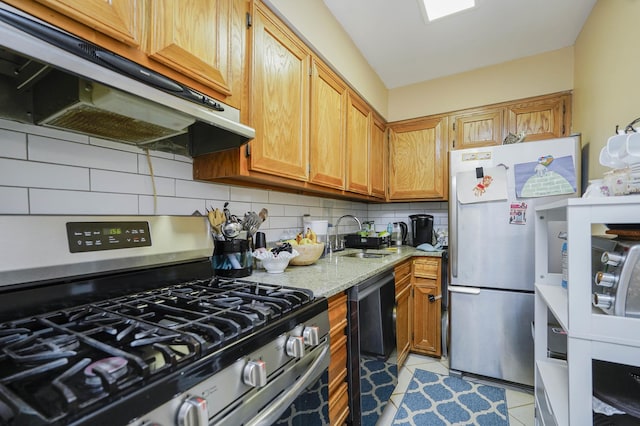 9729 4th Ave Unit 3-C, New York City, NY 11209 - kitchen featuring appliances with stainless steel finishes, under cabinet range hood, a sink, tasteful backsplash, and light stone countertops