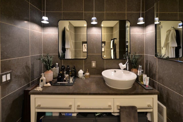 bathroom with decorative backsplash, tile walls, and vanity