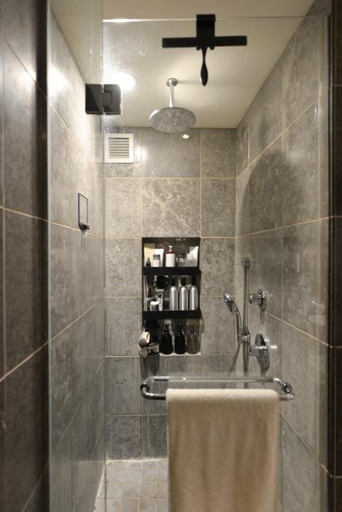 bathroom with a tile shower