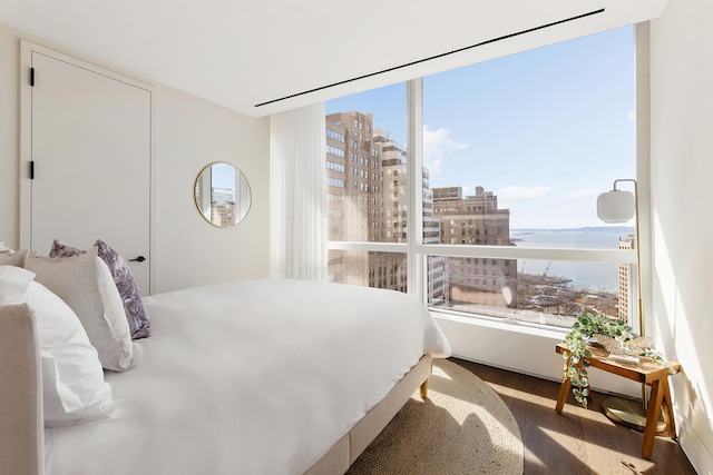 77 Greenwich St Unit 31-A, New York City, NY 10006 - bedroom featuring a water view, a view of city, and wood finished floors