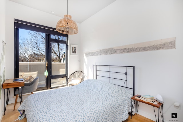 bedroom featuring access to outside and light wood-style flooring