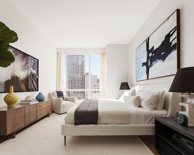 bedroom with light colored carpet and a view of city