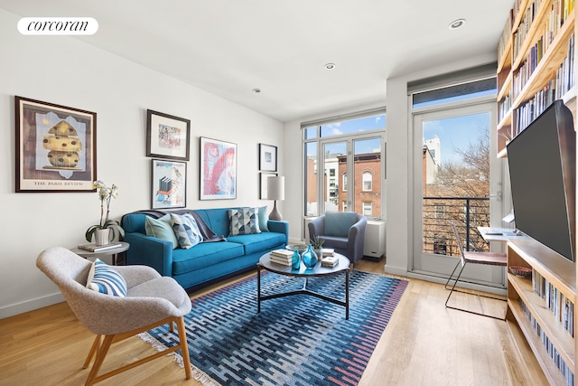 living area featuring recessed lighting, wood finished floors, visible vents, and baseboards