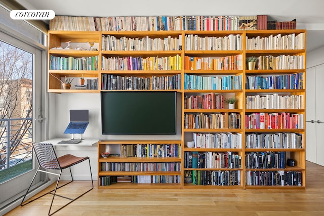 office area with bookshelves and wood finished floors