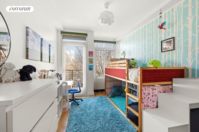 bedroom with wallpapered walls, visible vents, and light wood finished floors