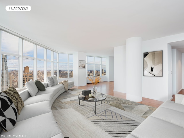 living area with visible vents, light wood-style flooring, and a healthy amount of sunlight